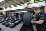 Foto zur News: Lotus-Mechaniker arbeitet mit den Pirelli-Reifen