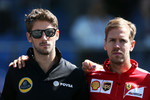 Foto zur News: Romain Grosjean (Lotus), Sebastian Vettel (Ferrari) und Justin Wilson (Andretti)