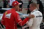 Foto zur News: Sebastian Vettel (Ferrari) und Valtteri Bottas (Mercedes)