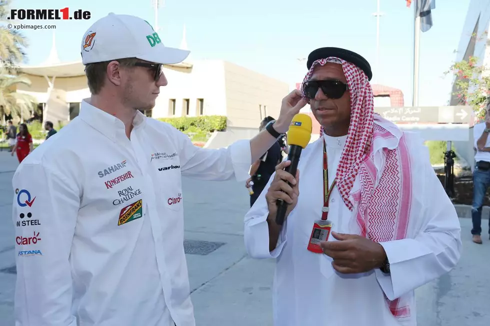 Vor dem Rennen: Nico Hülkenberg rückt bei Kai Ebel, natürlich in landestypischer Kluft unterwegs (und damit besser angezogen als sonst, wie böse Zungen unken), den Sonnenschutz zurecht. Foto zur News: Vor dem Rennen: Nico Hülkenberg rückt bei Kai Ebel, natürlich in landestypischer Kluft unterwegs (und damit besser angezogen als sonst, wie böse Zungen unken), den Sonnenschutz zurecht.