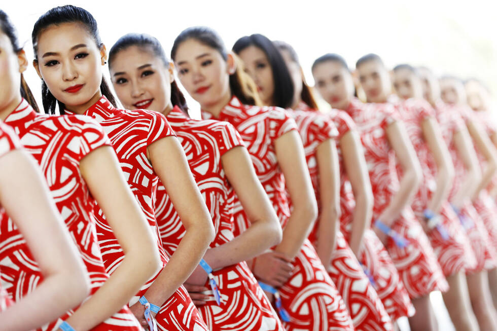 Foto zur News: Die Aufgabe der chinesischen Gridgirls ist eine einfache: immer brav lächeln.